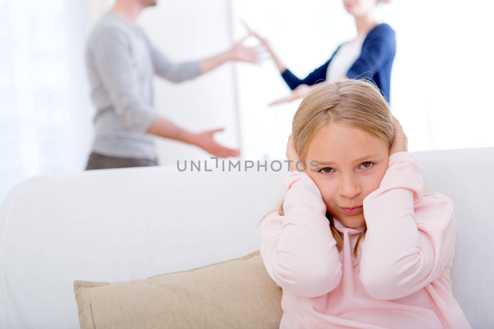 View of a Young child blocked up her ears while arguing