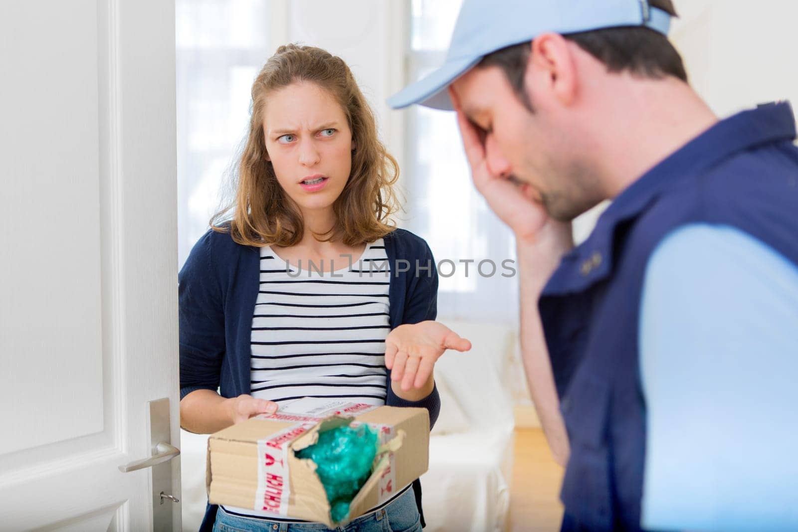 View of a Young attractive woman angry against delivery man
