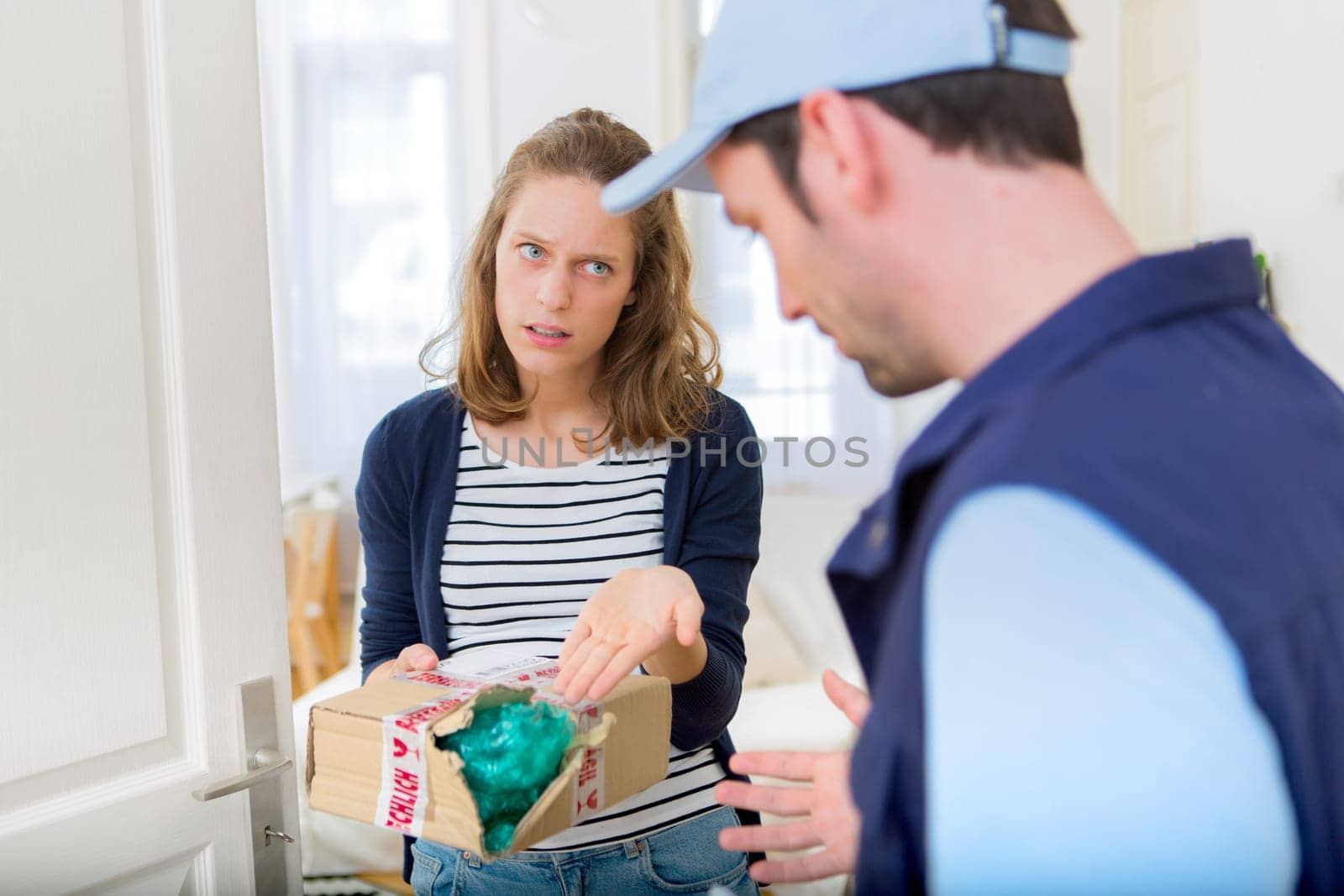 View of a Young attractive woman angry against delivery man
