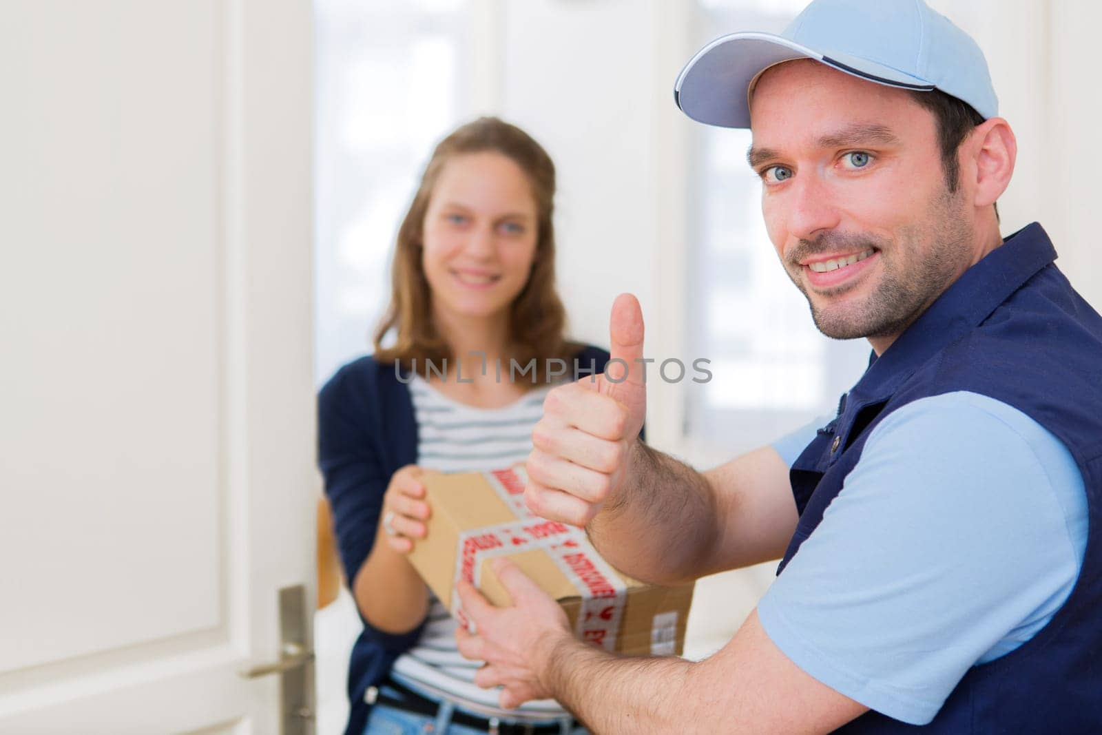 View of a Delivery man handing over a parcel to customer