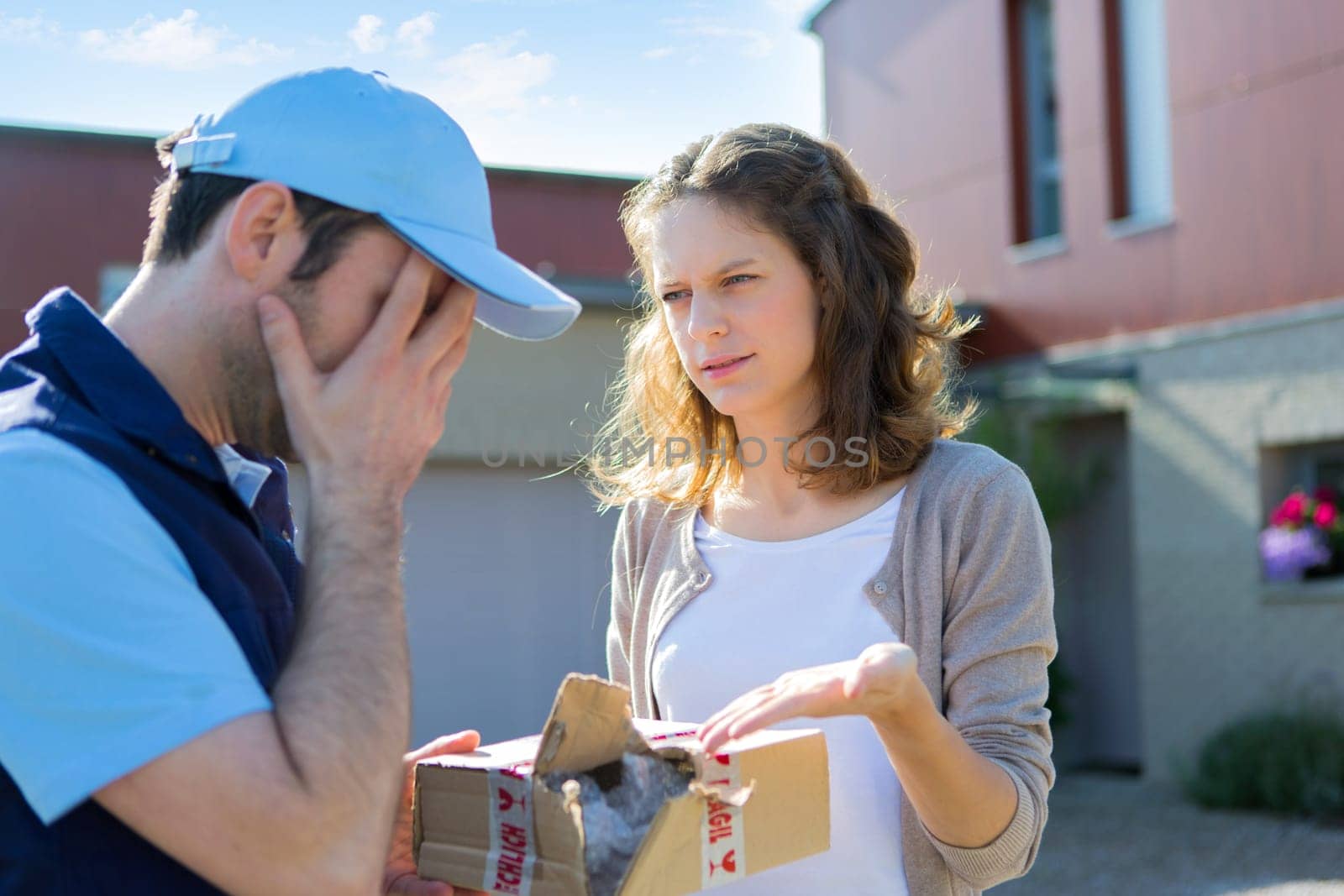 View of a Young attractive woman angry against delivery man