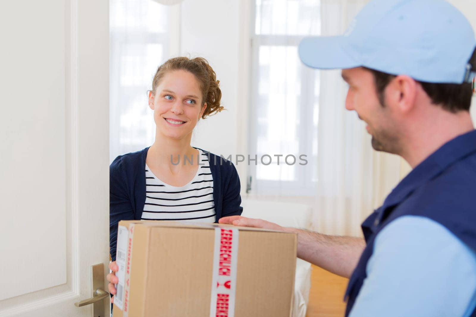 View of a Delivery man handing over a parcel to customer