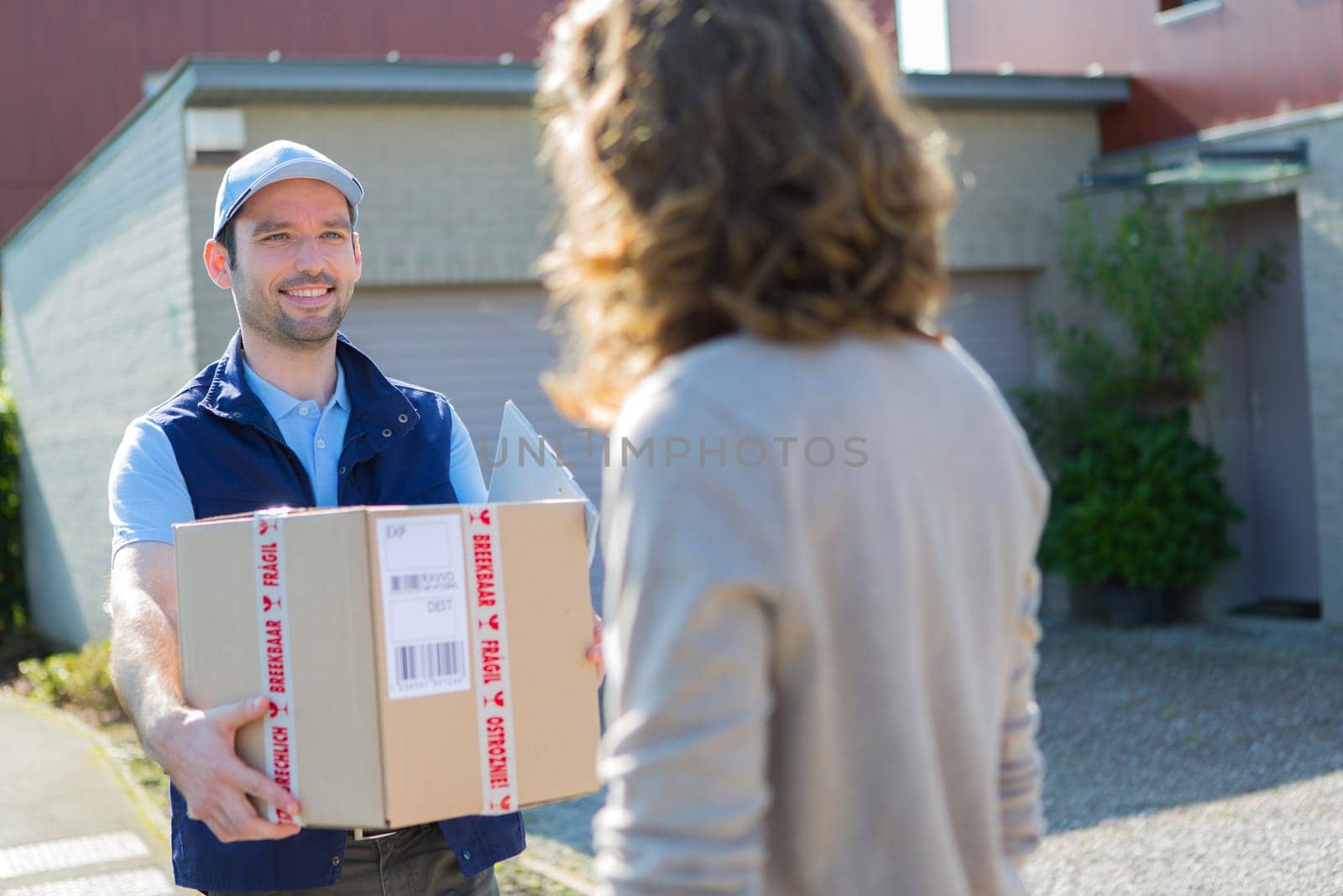 View of a Young attractive delivery man on his way to customer