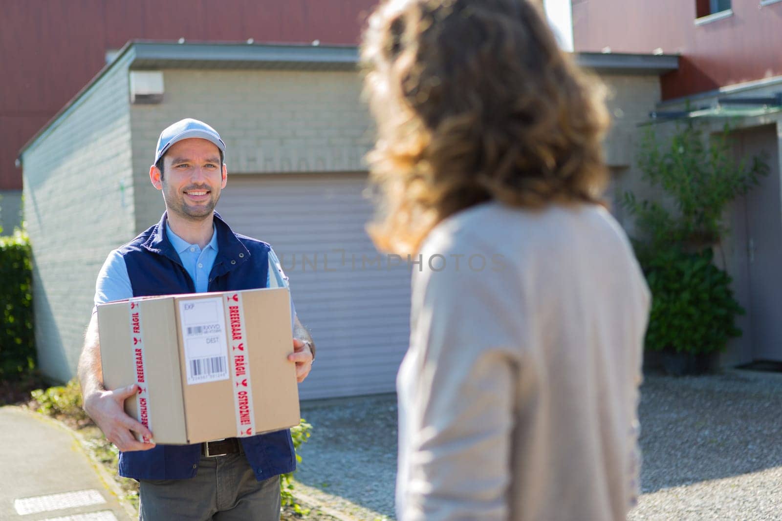 View of a Young attractive delivery man on his way to customer