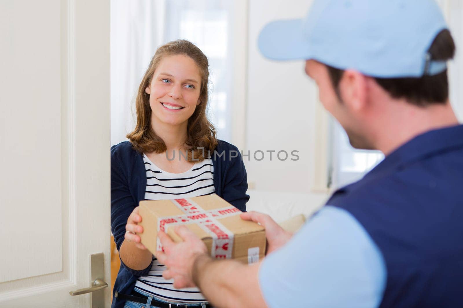 View of a Delivery man handing over a parcel to customer