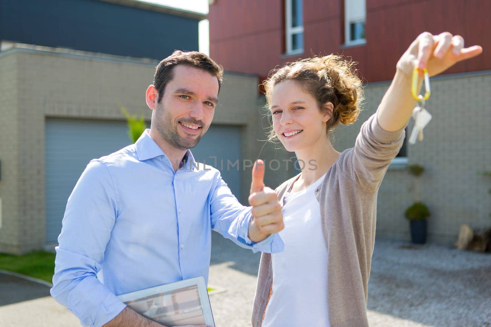 View of a Real estate agent handing over keys