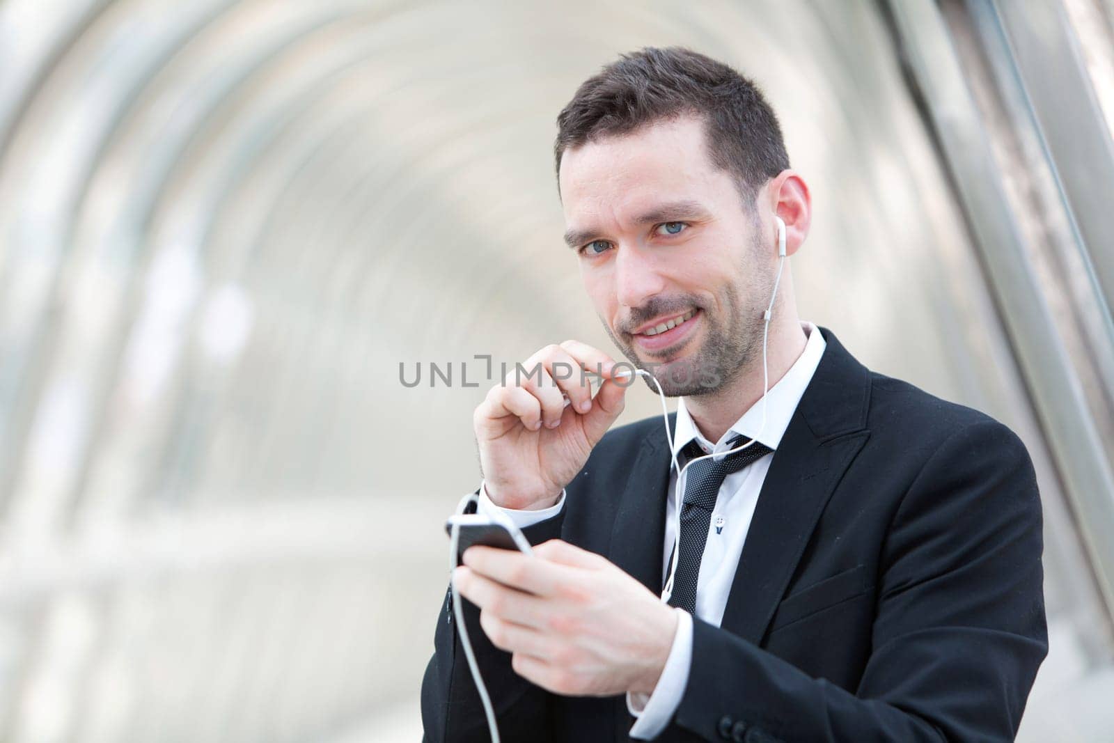 View of an attractive businessman using handsfree set