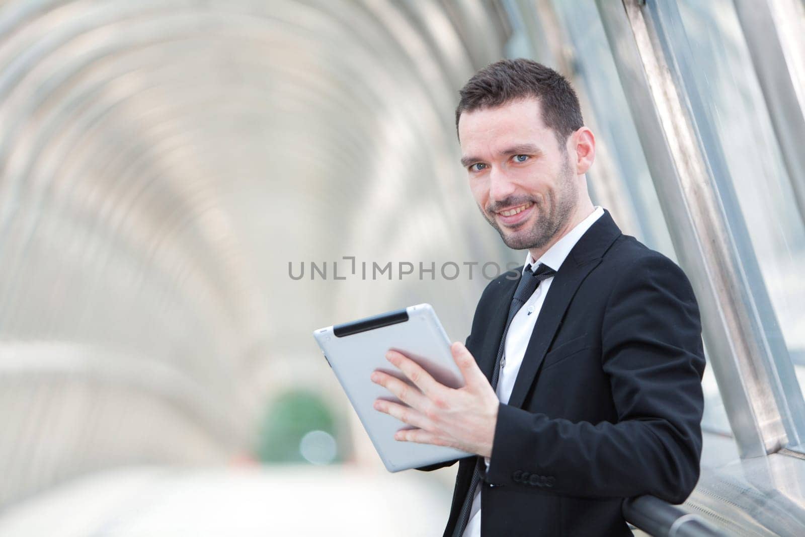 View of an attractive businessman using a tablet