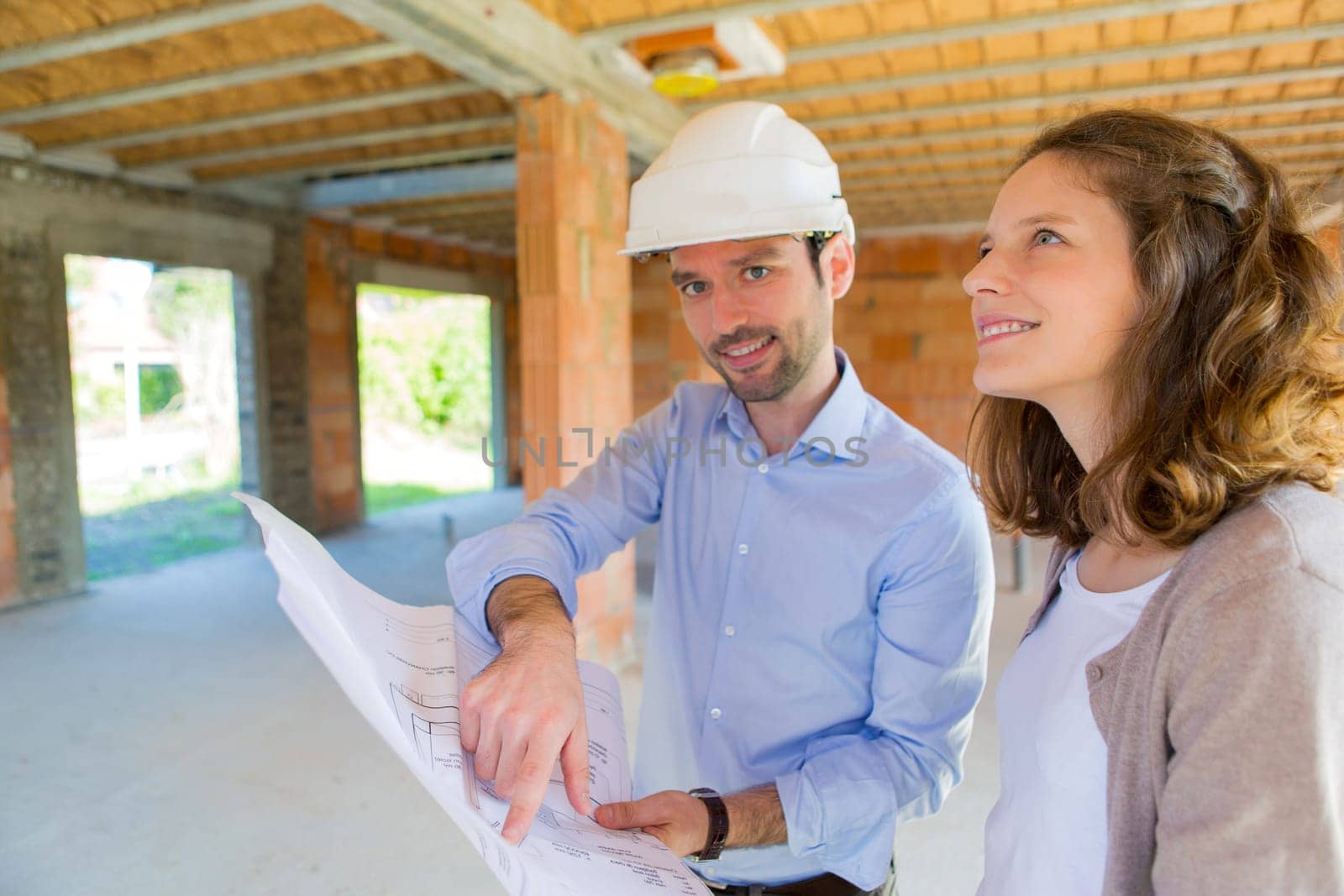 View of a Young woman and architect on construction site