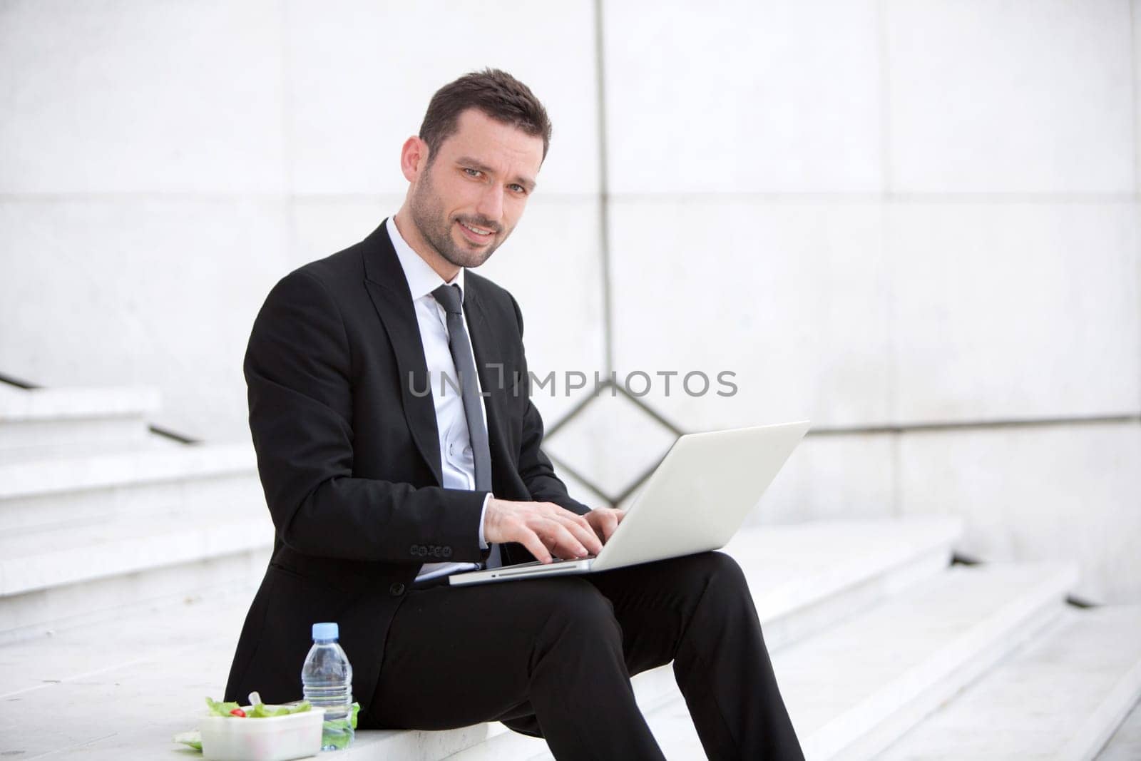 Attractive businessman keep working during lunch break