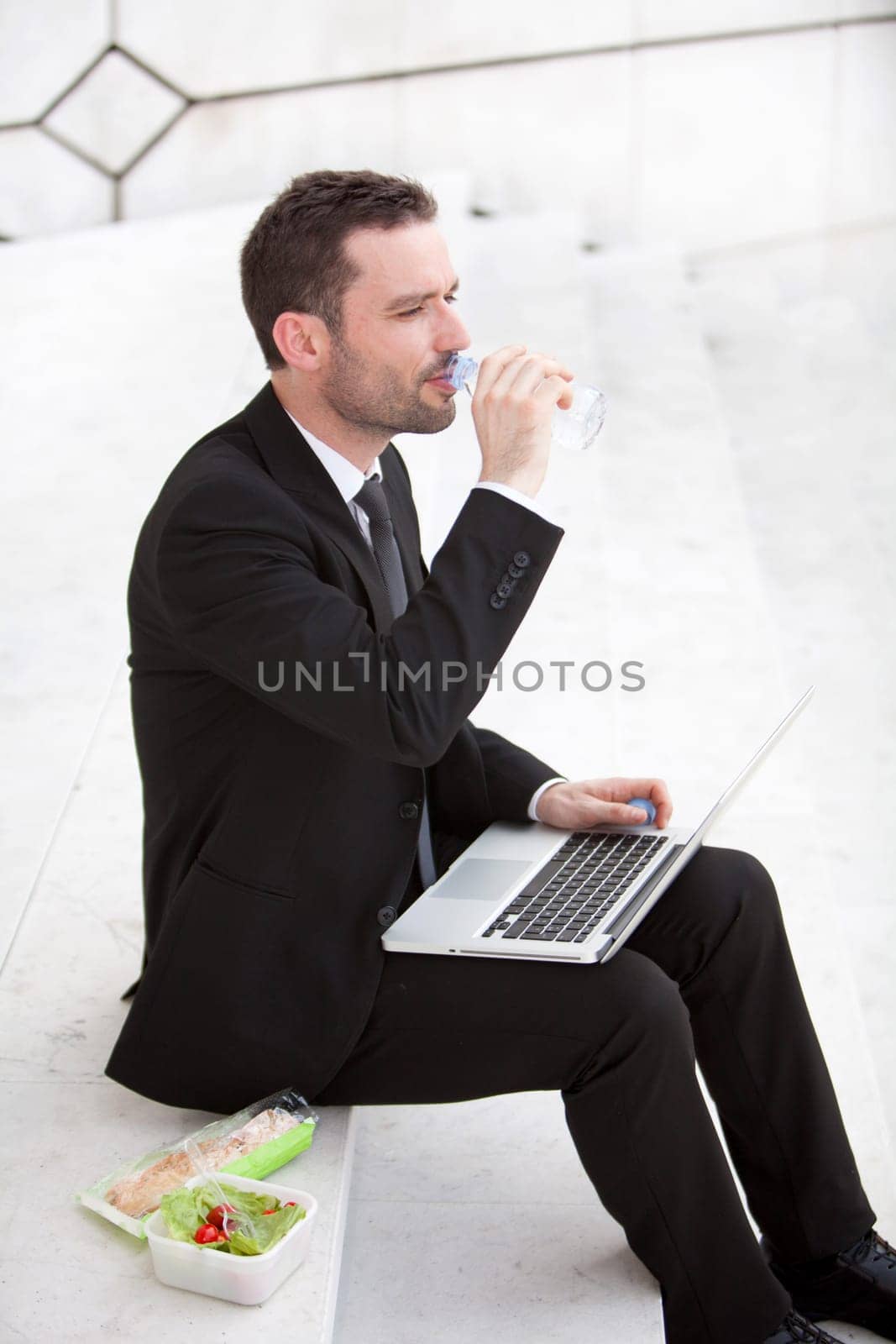Attractive businessman keep working during lunch break