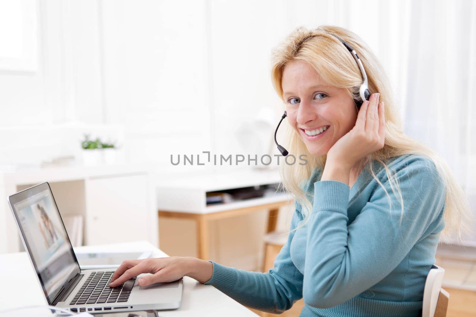 View of Young attractive woman blonde chatting on laptop