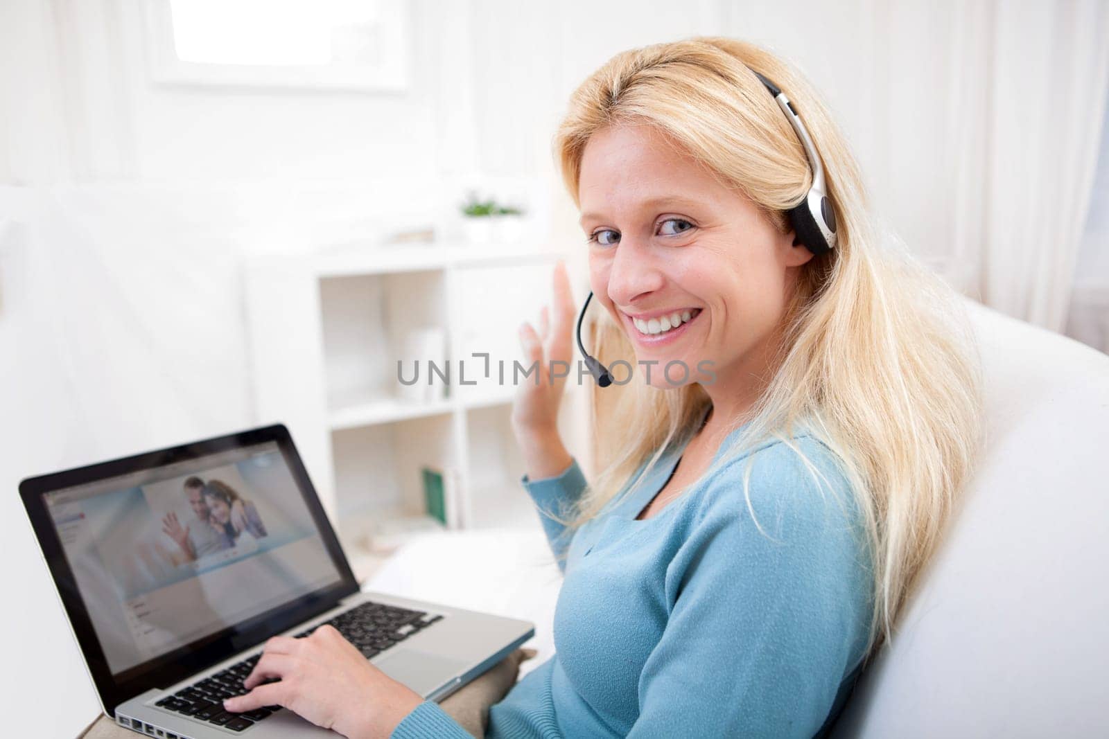 View of Young attractive woman blonde chatting on laptop