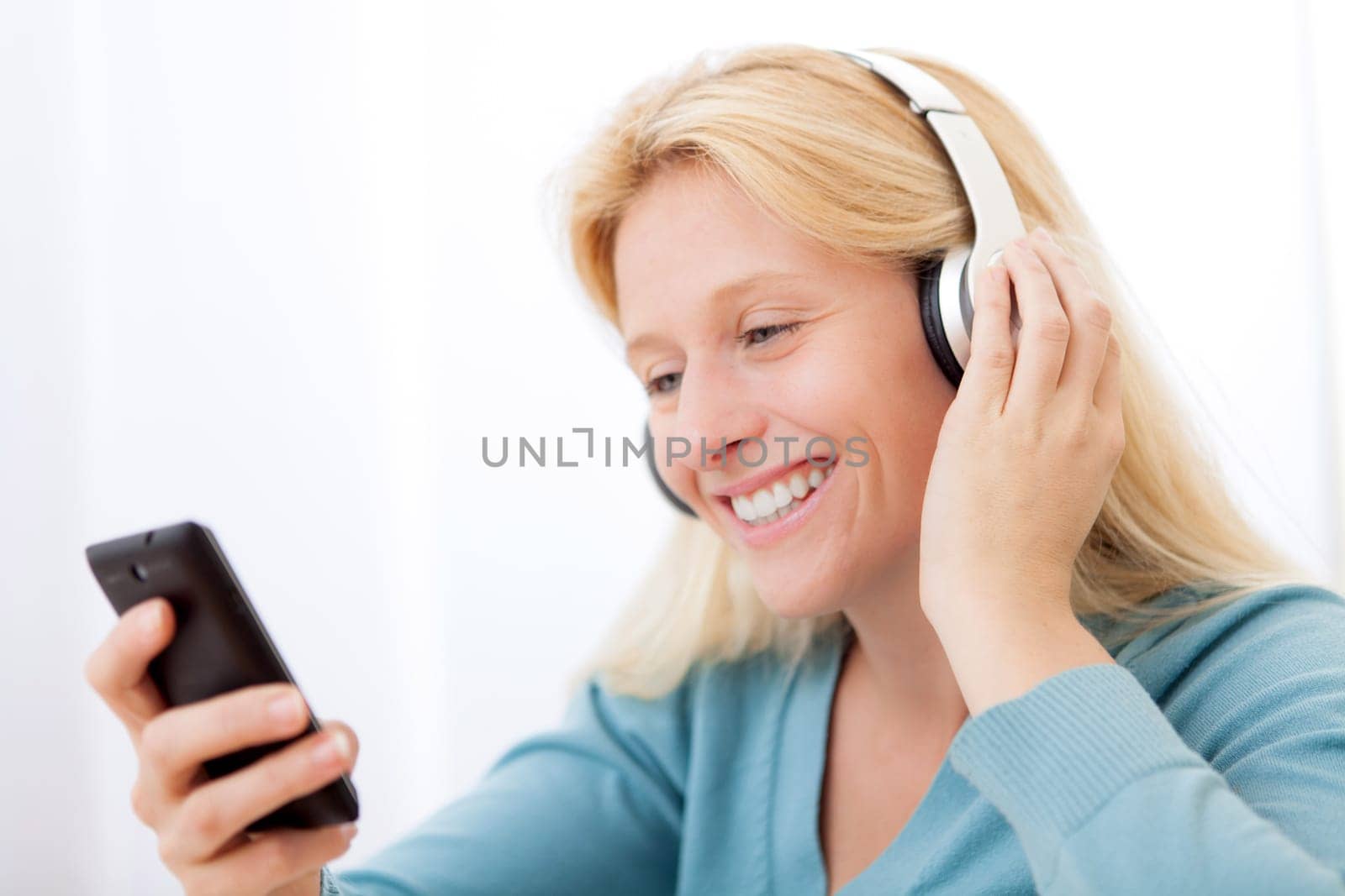 View of a young attractive woman listenning music