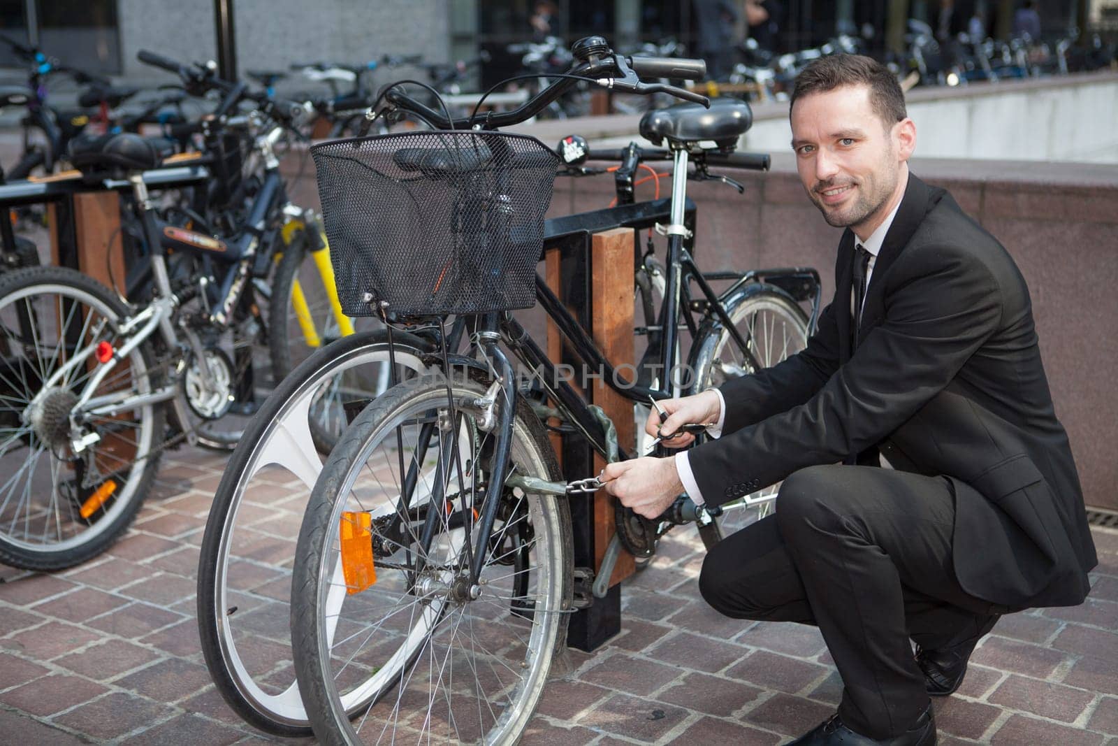 View of a Businessman unlock his bike after a day of work