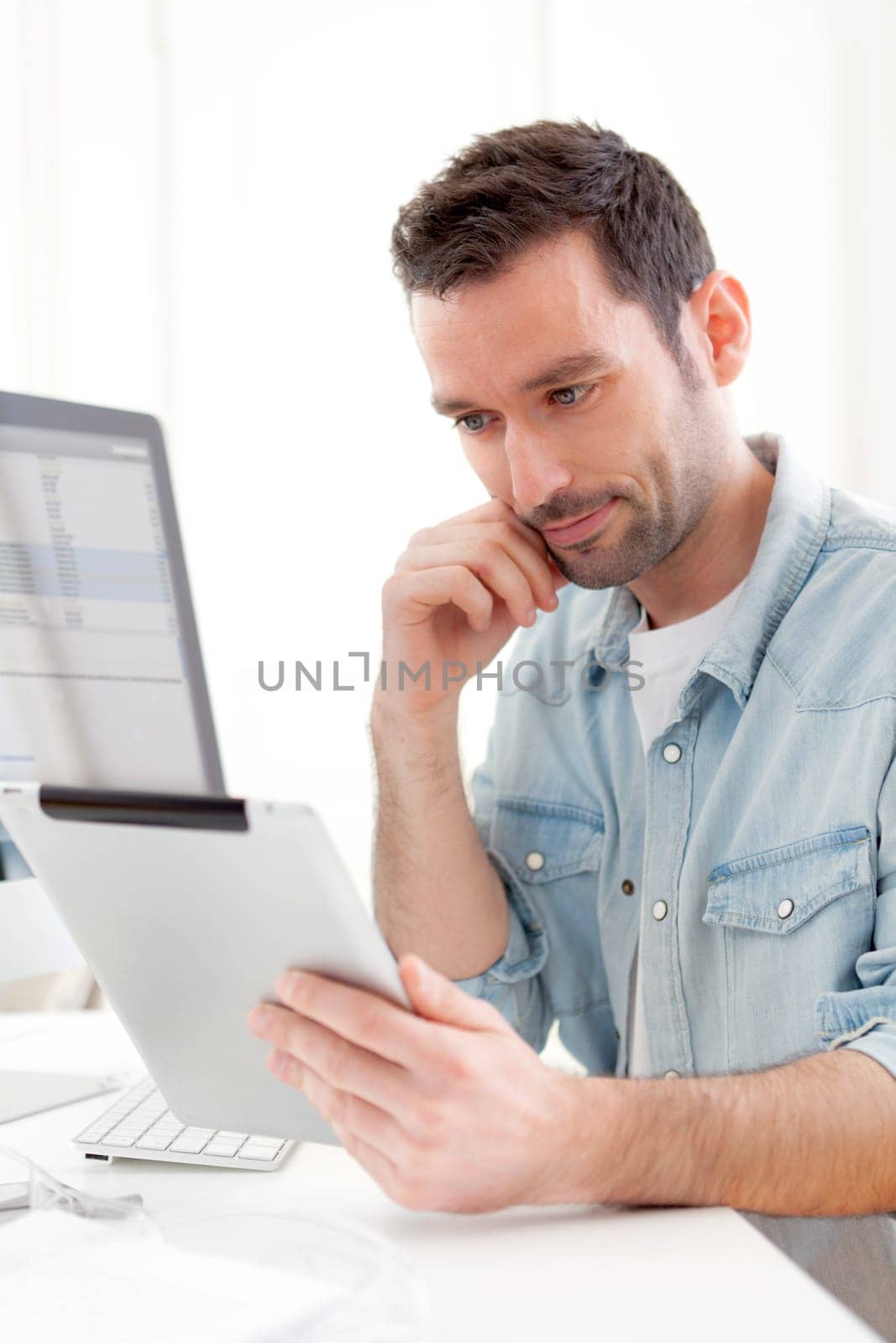 View of a Young relaxed man using tablet at home