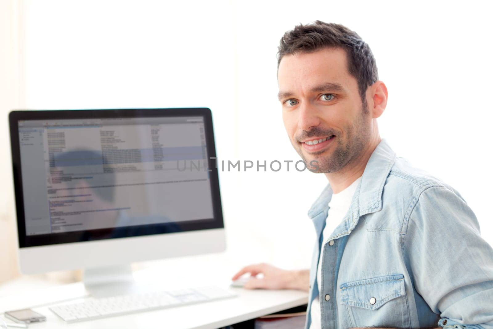 View of a young relaxed man using computer