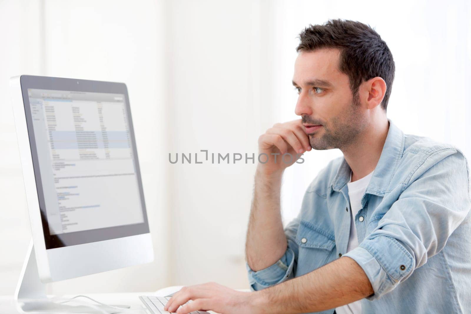 View of a young relaxed man using computer