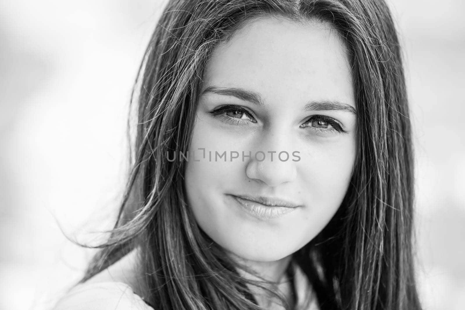 Outdoor portrait of beautiful teenage girl in spring in black and white.