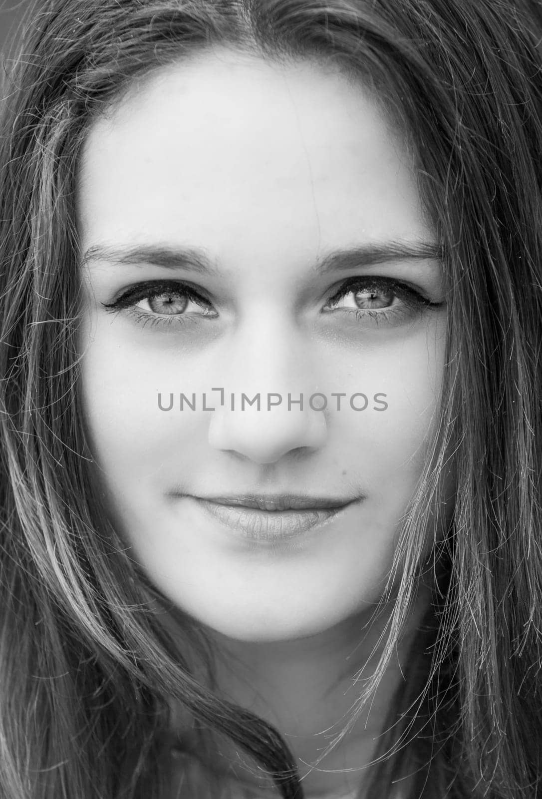 Outdoor portrait of beautiful teenage girl in spring in black and white.