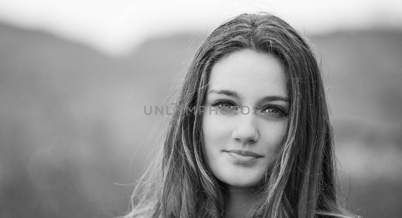 Outdoor portrait of beautiful teenage girl in spring in black and white.