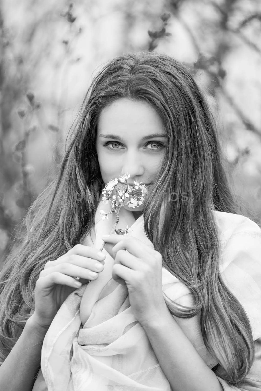 Outdoor portrait of beautiful teenage girl in spring in black and white.