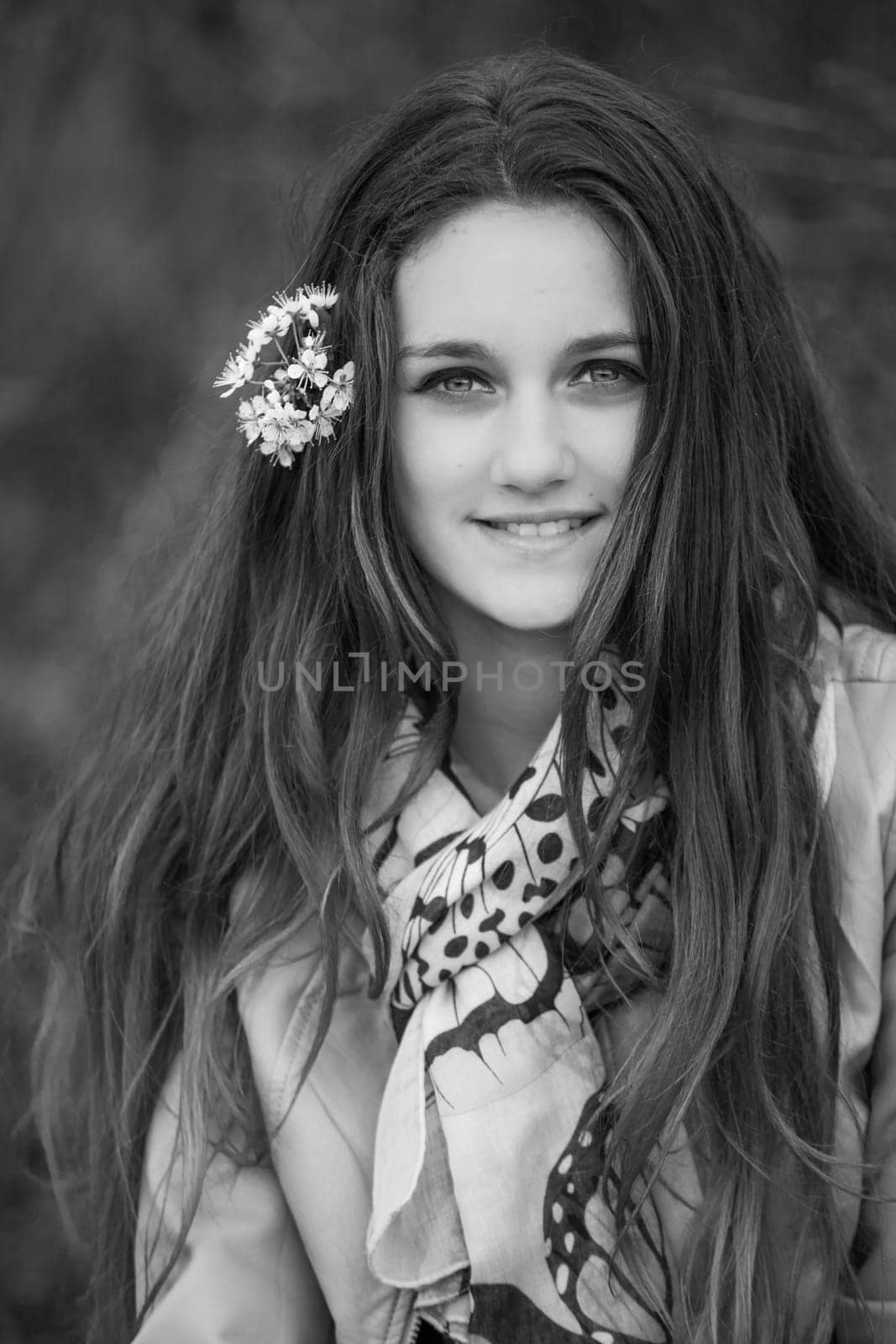 Outdoor portrait of beautiful teenage girl in spring in black and white.