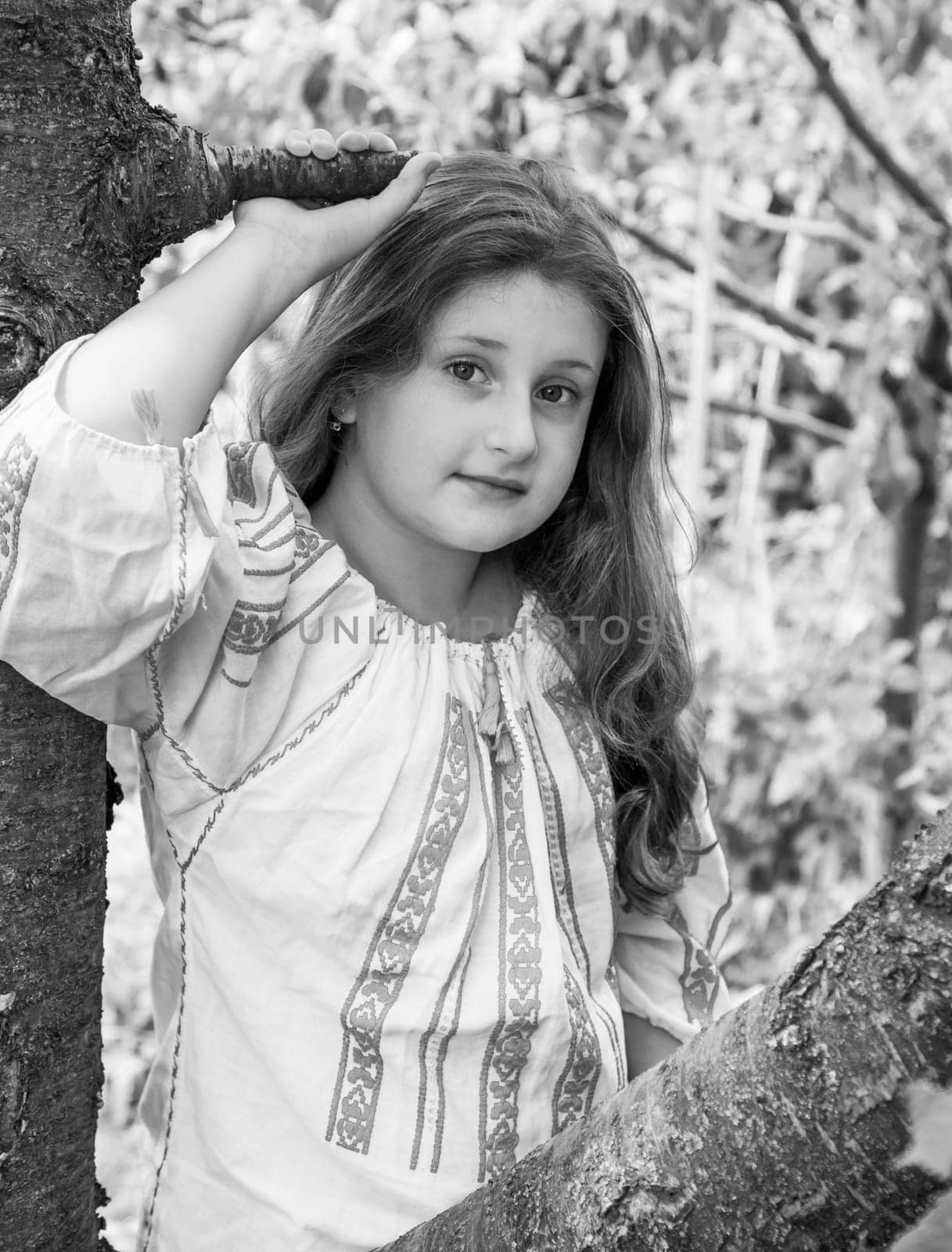 Portrait of a 10 year old girl wearing a Romanian traditional blouse.