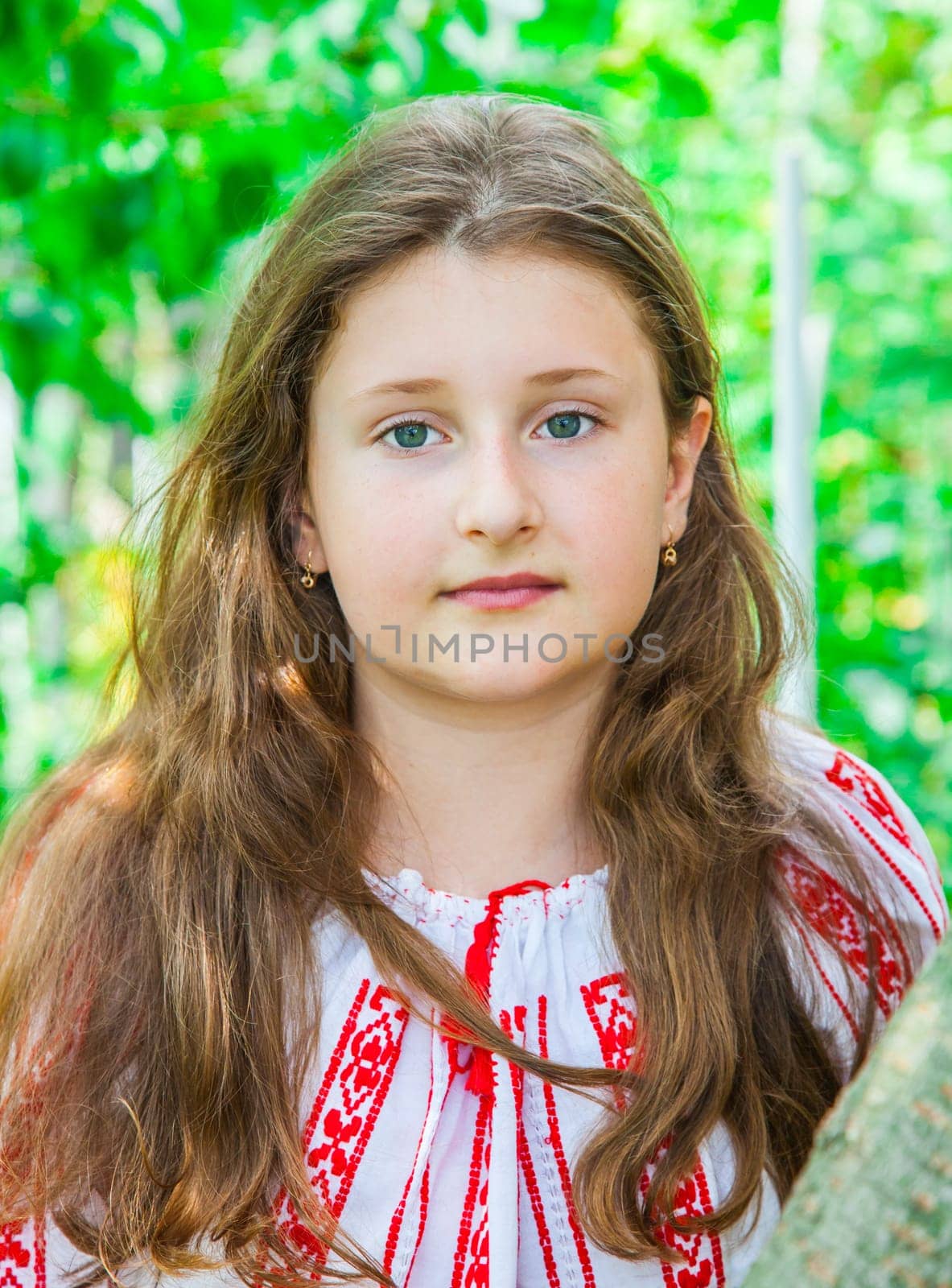 Portrait of a 10 year old girl wearing a Romanian traditional blouse.