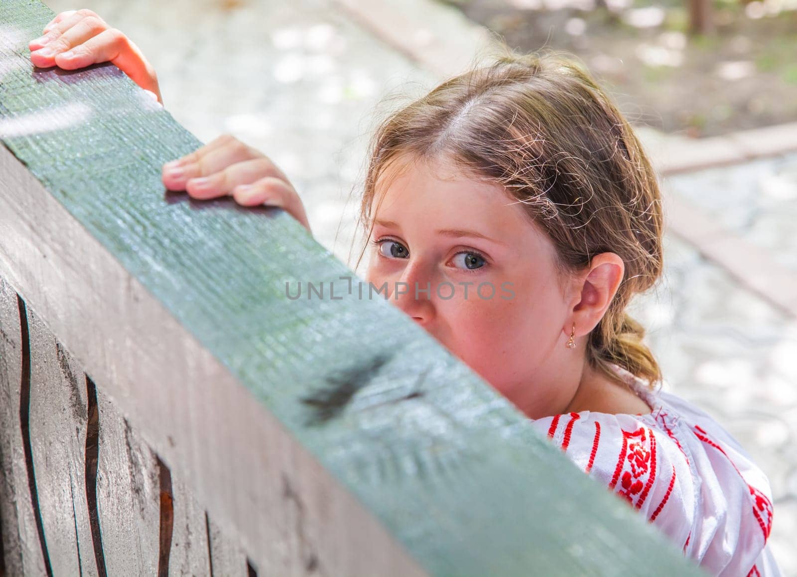 Portrait of a 10 year old girl wearing a Romanian traditional blouse.