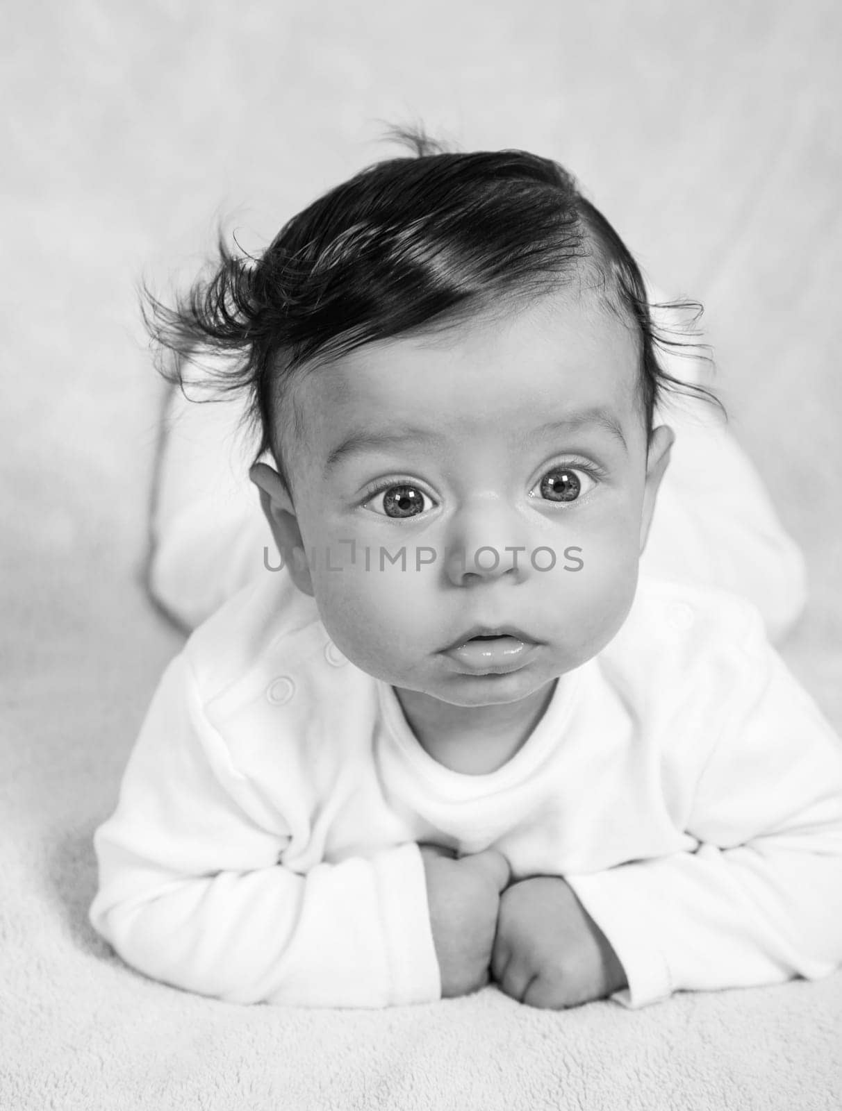 Portrait of an adorable baby boy in black and white.