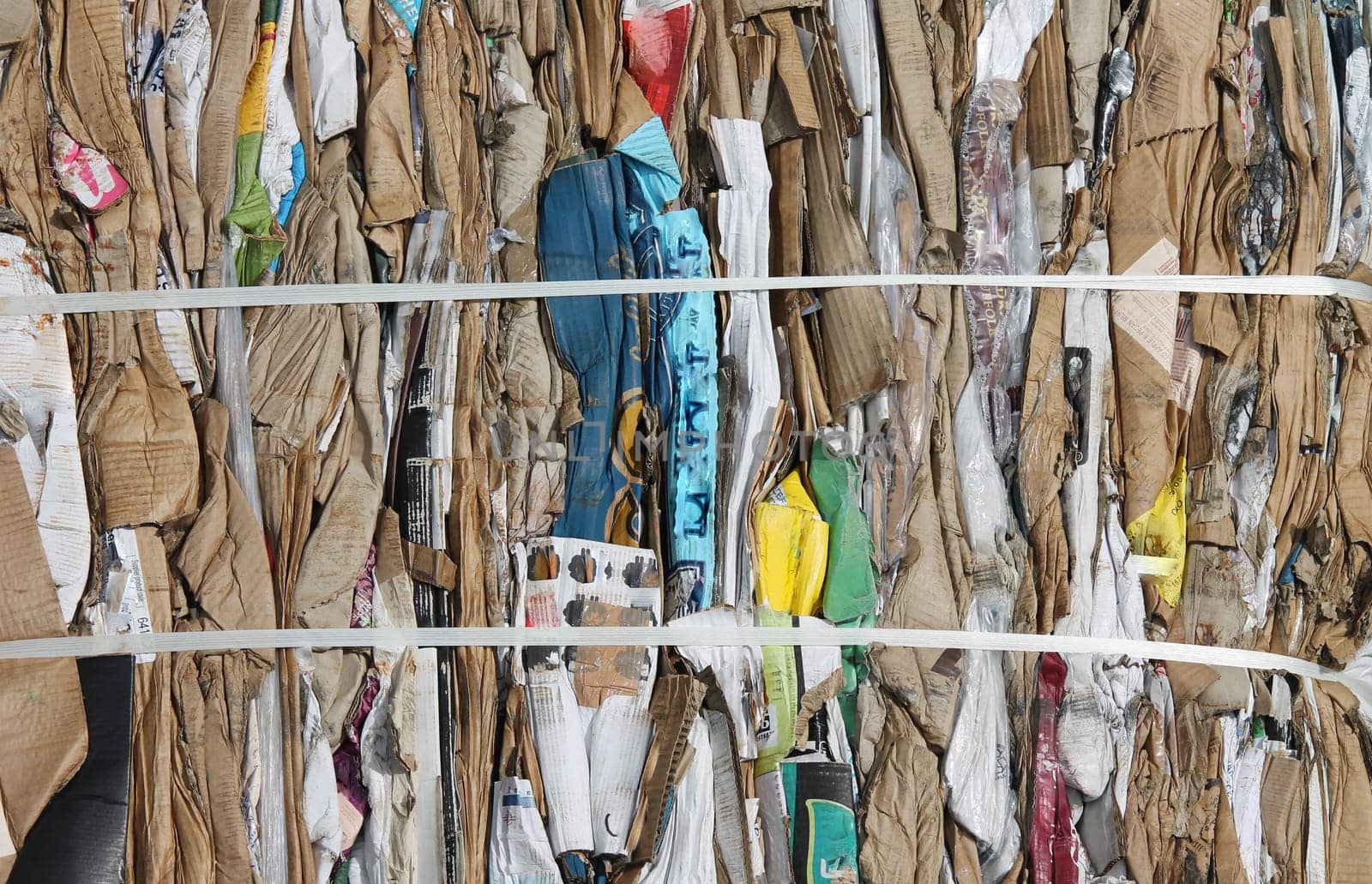 Recycling cardboard packaging concept with stacks of compressed baled corrugated paper garbage as a symbol to recycle for conservation