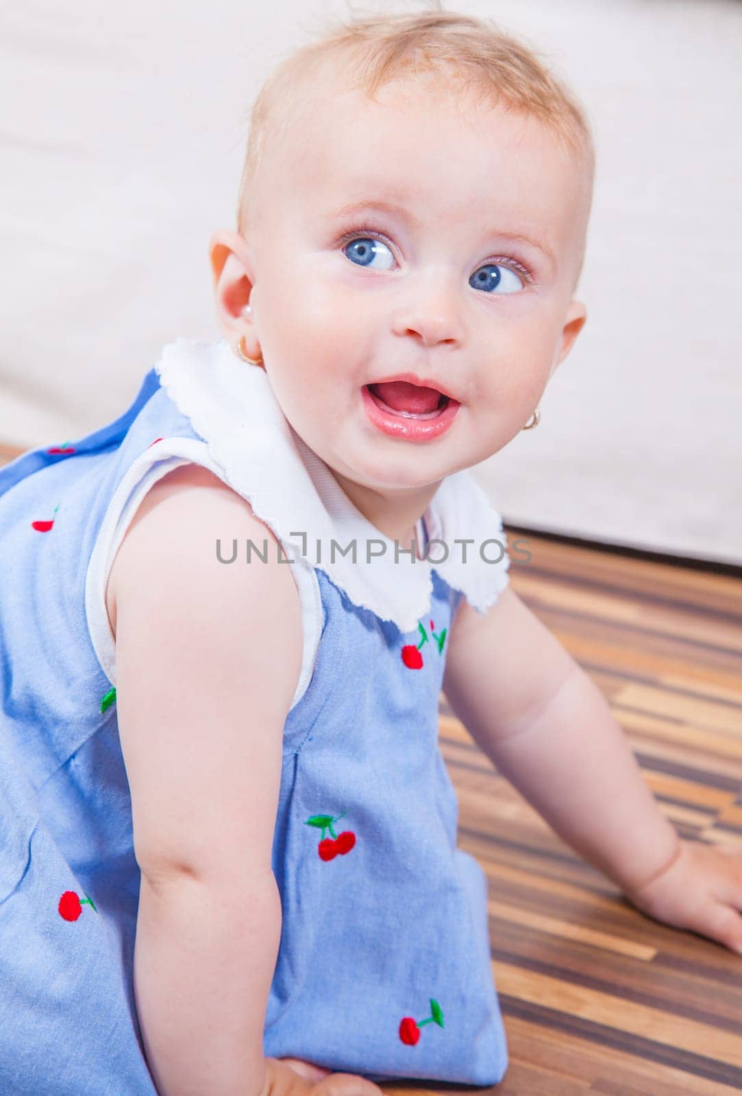 Portrait of 1 year old baby girl playing at home.