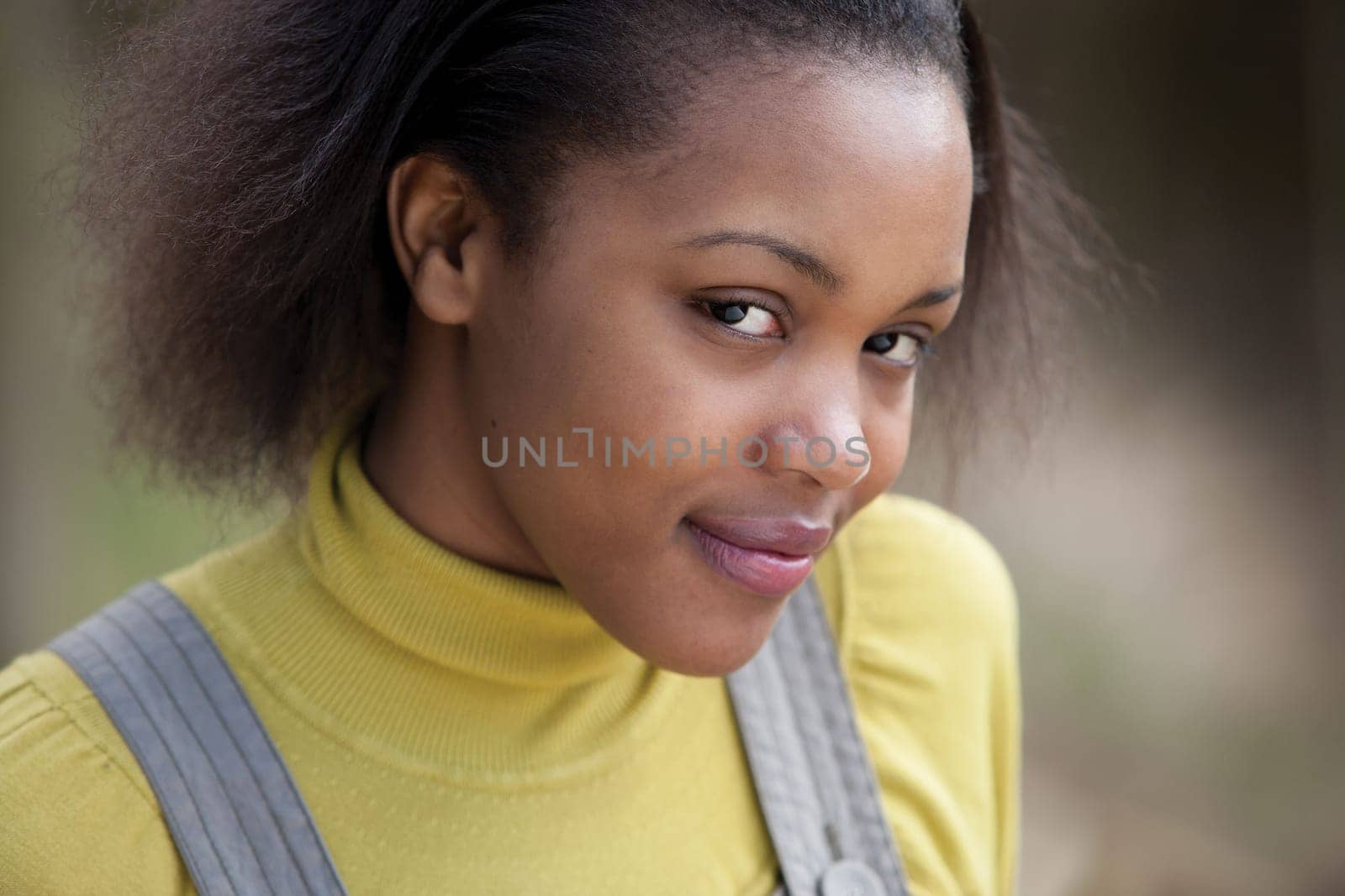 Close up portrait of an attractive young woman standing outside
