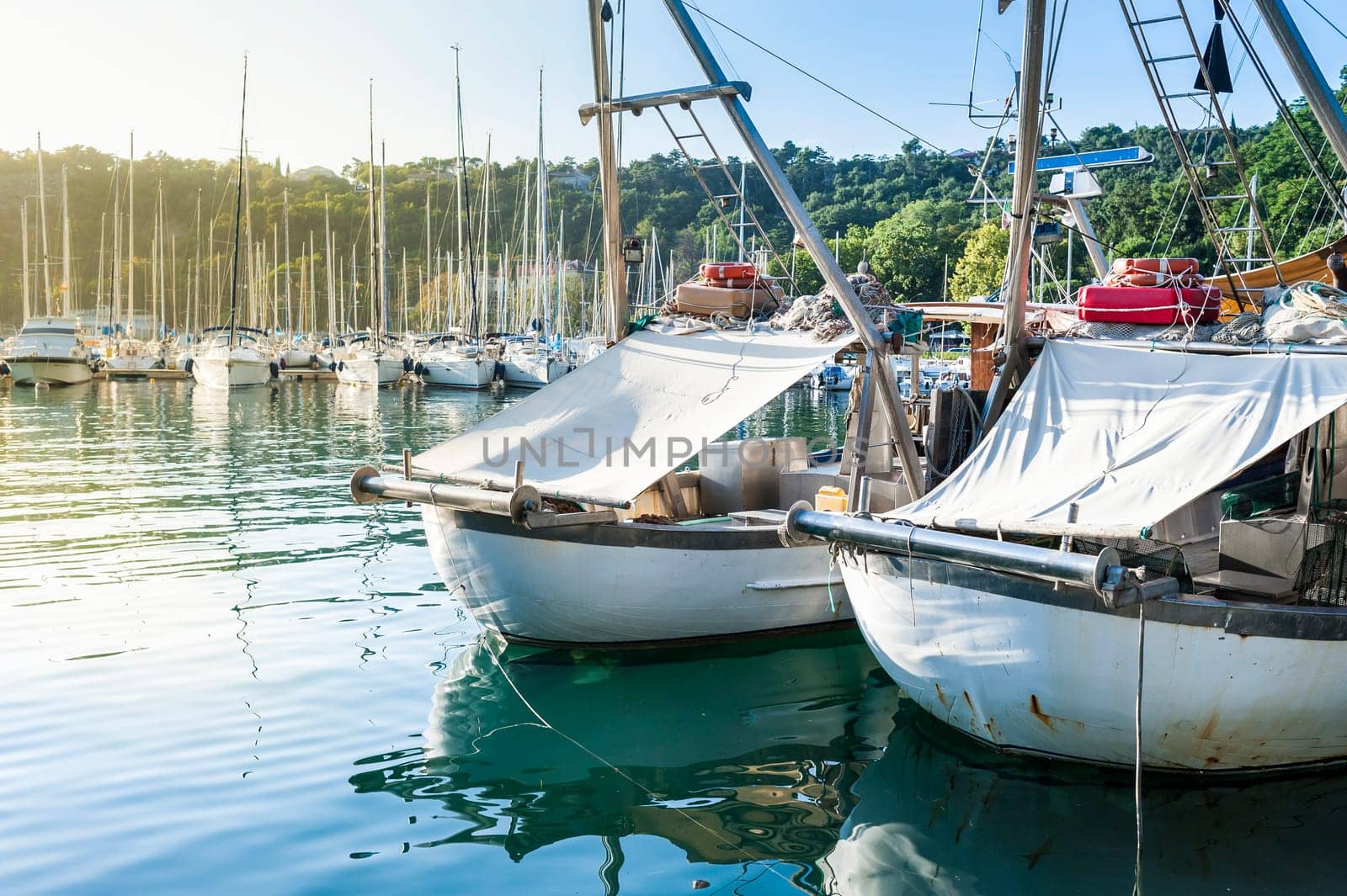 Fishing boats in the port of Sistiana, Trieste, Italy at sunset