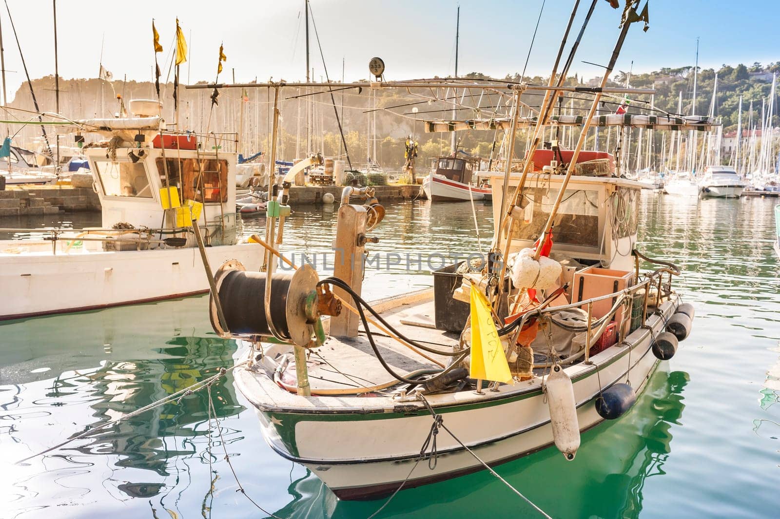 Fishing boats in the port of Sistiana, Trieste, Italy at sunset