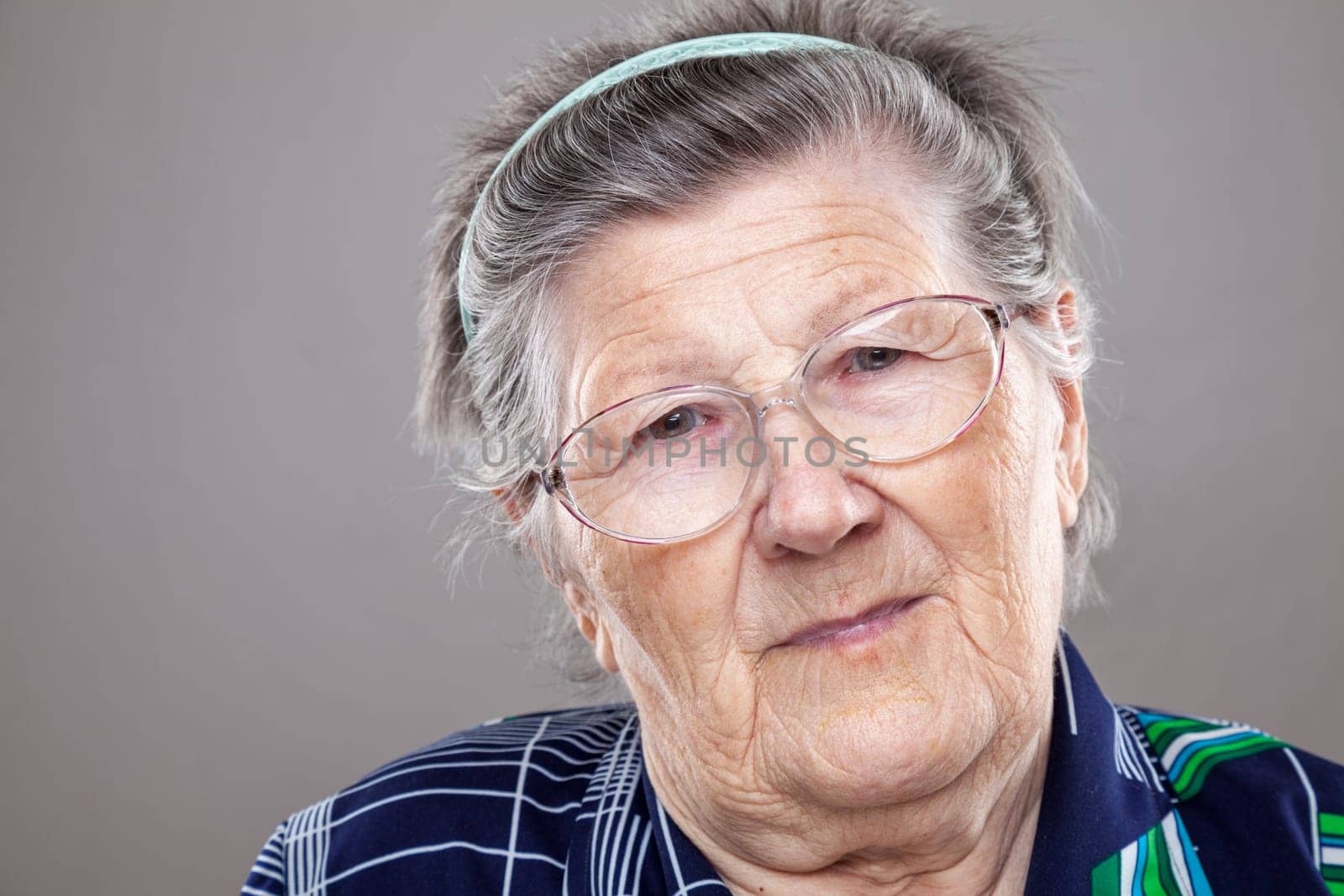 Closeup portrait of an elderly woman with glasses