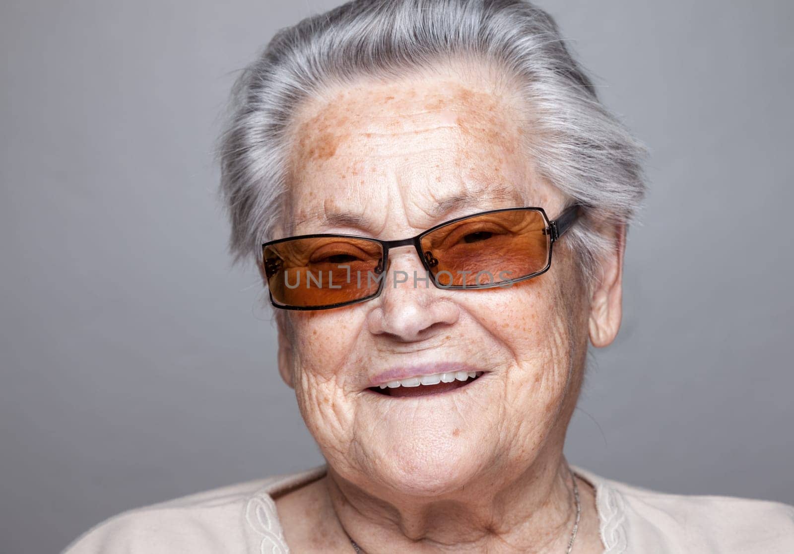 Closeup portrait of an elderly woman with glasses