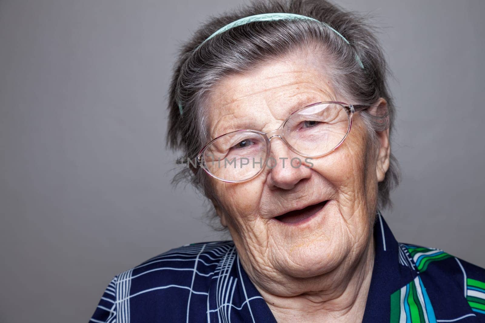 Closeup portrait of an elderly woman with glasses