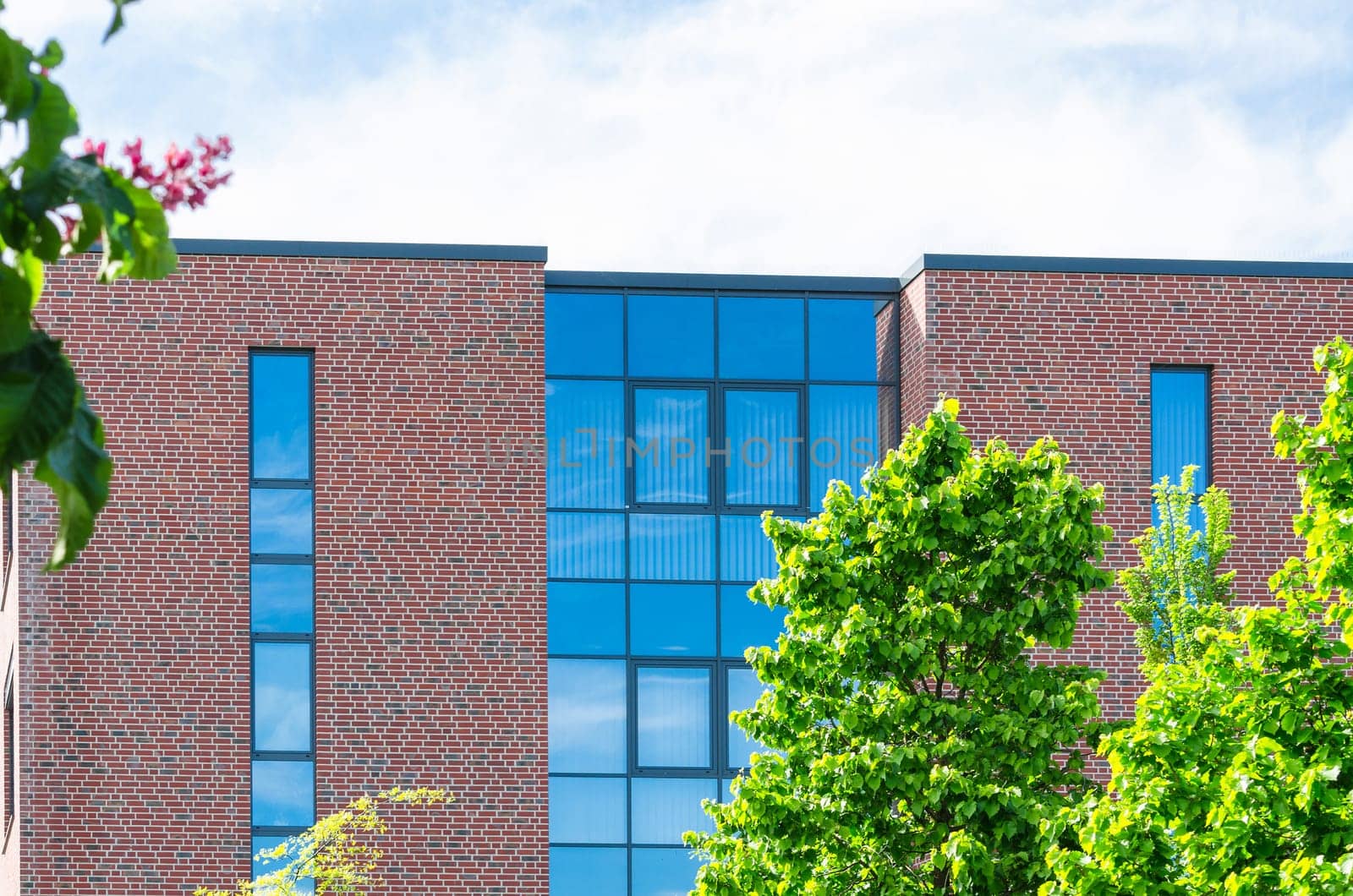 Real estate picture of a modern office building with beautiful glass front.