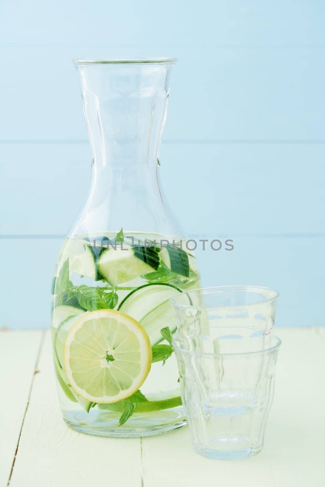 Flavoured water or infused water with cucumbers,lemons and mint in a carafe