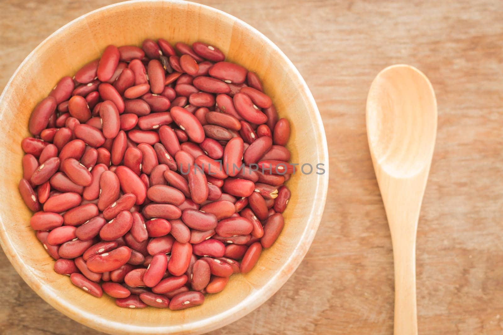 Raw red kidney bean in wooden bowl, stock photo