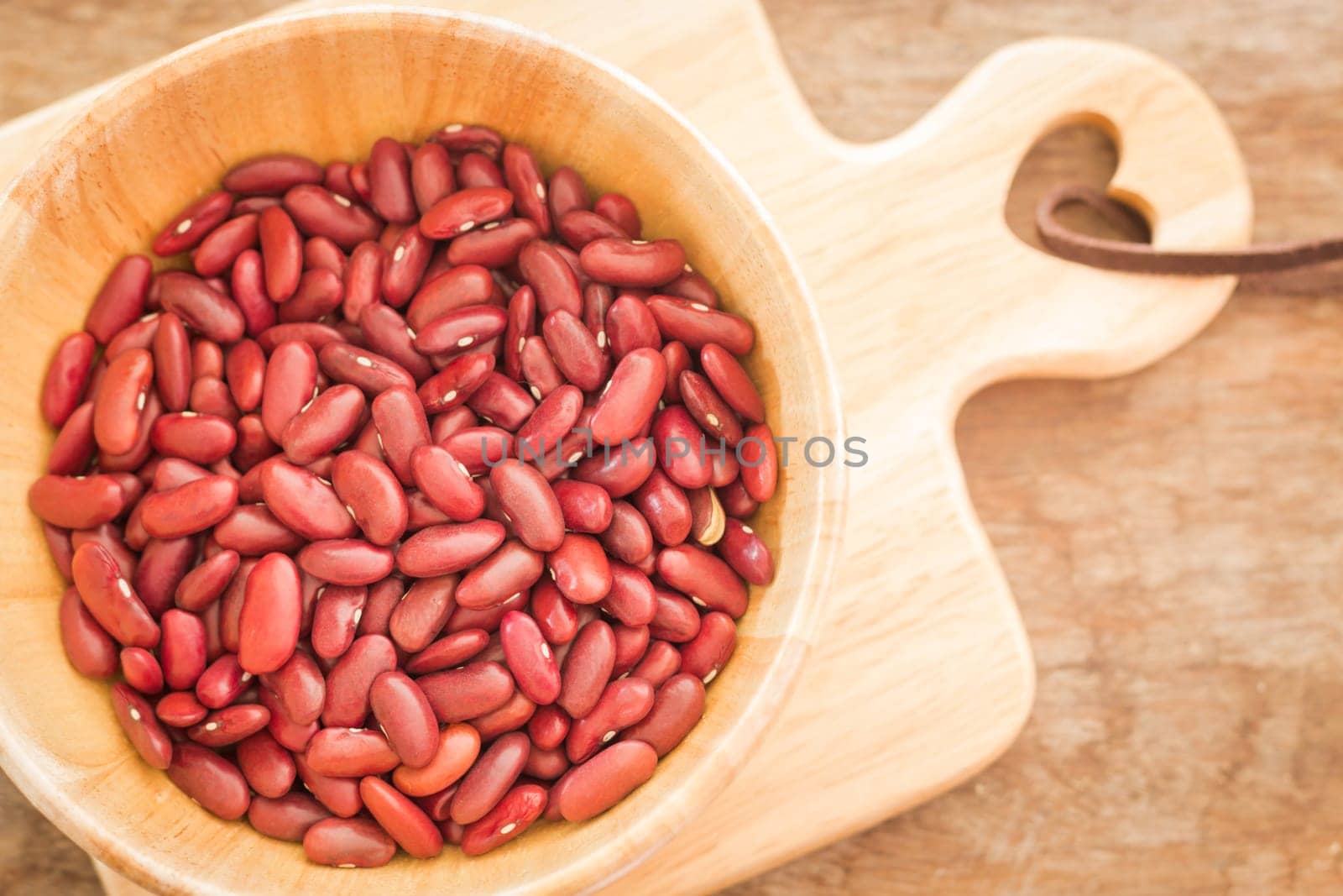 Raw red kidney bean in wooden bowl, stock photo