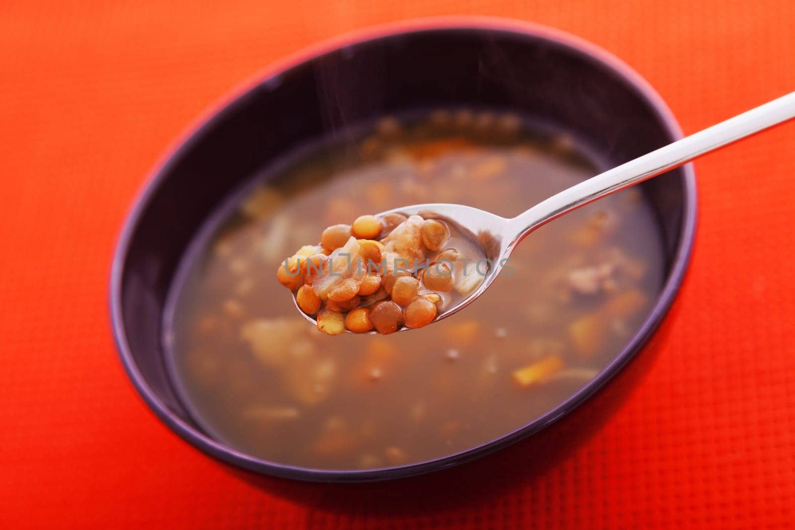 Lentil soup one portion with a spoon