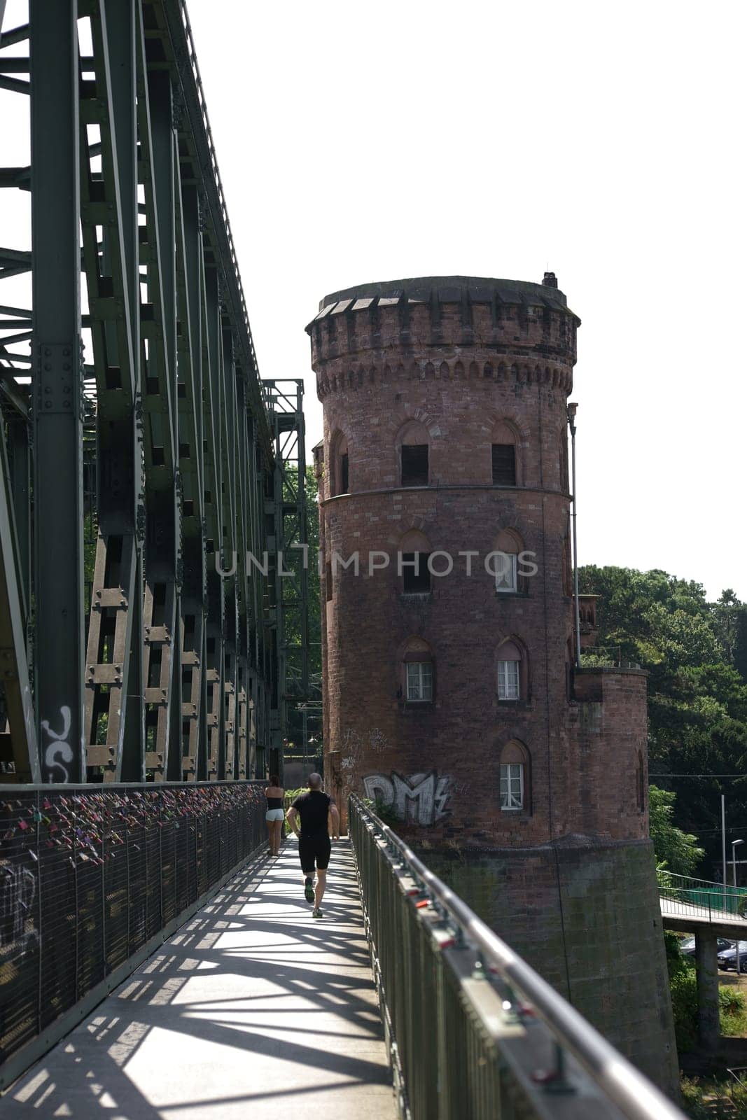 Mainz,Germany – July 25,2015: A jogger crosses the Mainz South Bridge towards a bridge tower on a sunny summer day in Mainz,Germany,July 25,2015.