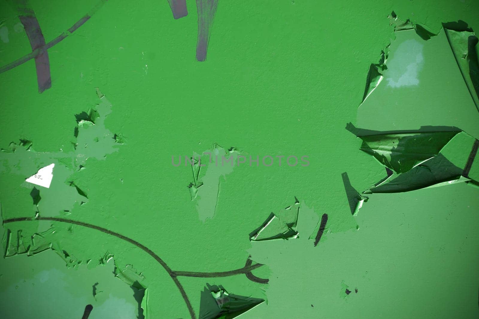 The close-up of a peeling paint layer or rust protection paint on a metal substrate.