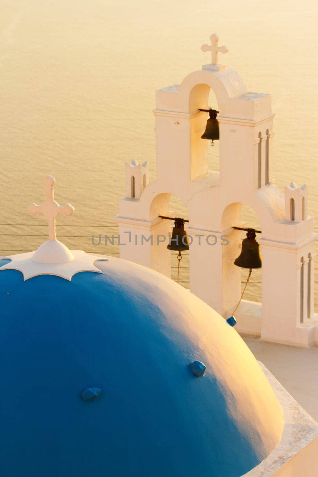 Famous church in Fira, Santorini at sunset