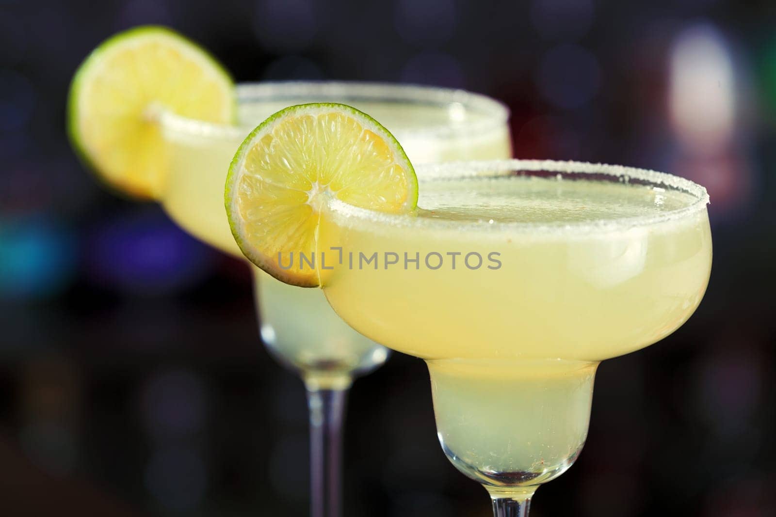 The margarita is a cocktail consisting of tequila mixed with orange-flavoured liqueur and lime or lemon juice, often served with salt on the glass rim.The drink is served shaken with ice, on the rocks, blended with ice (frozen margarita) or without ice (straight up)...Ingredients