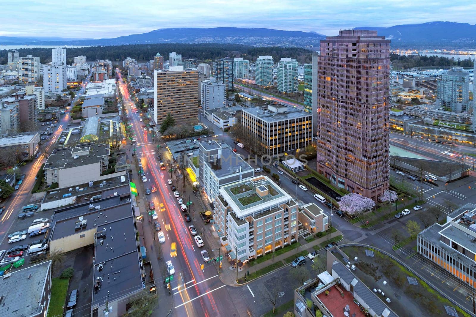 Vancouver British Columbia Canada Cityscape with Robson Street Light Trails and Stanley Park View at Dusk