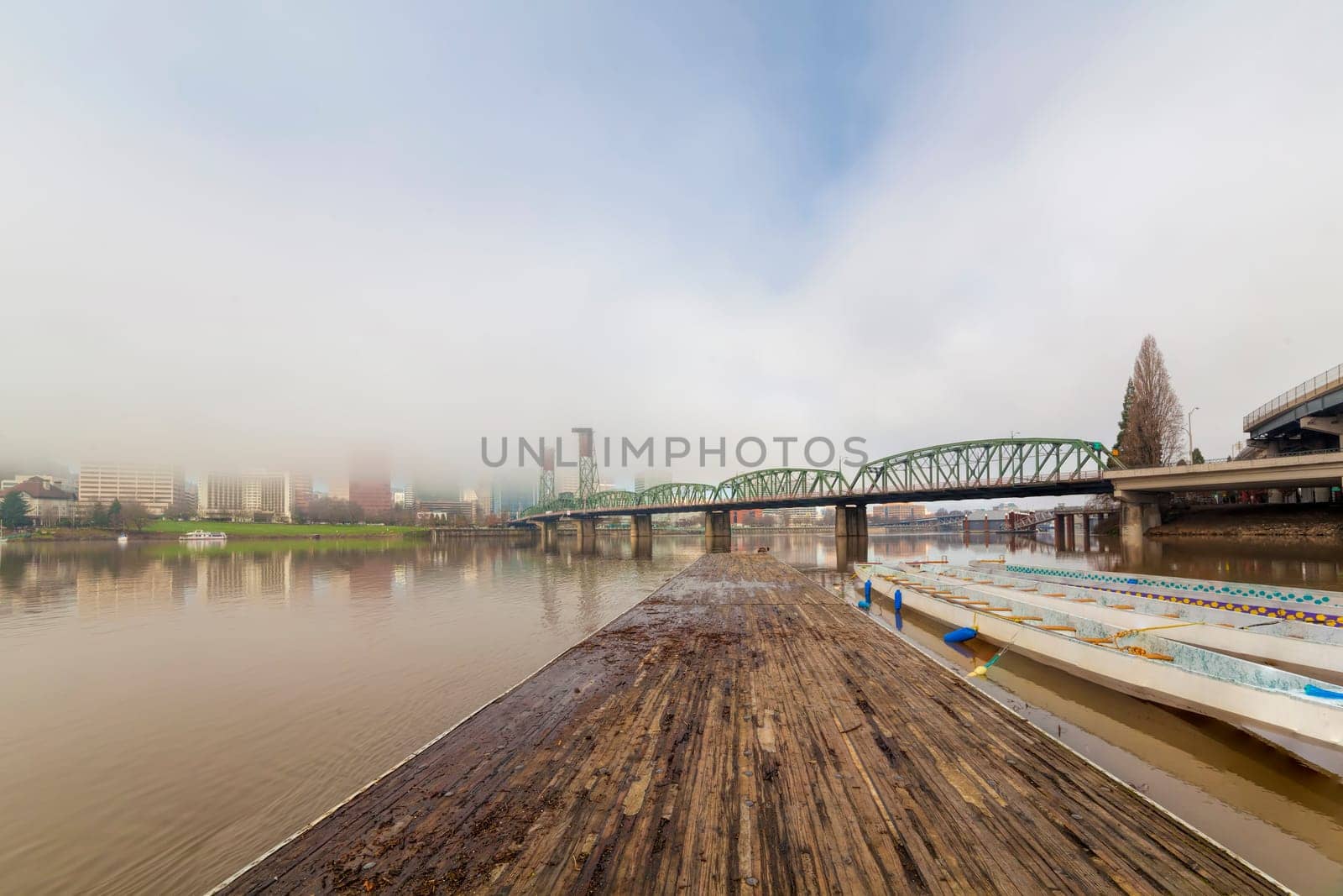 Floating Boat Dock on Willamette River with Portland Oregon Skyline and Hawthorne Bridge on Foggy Morning